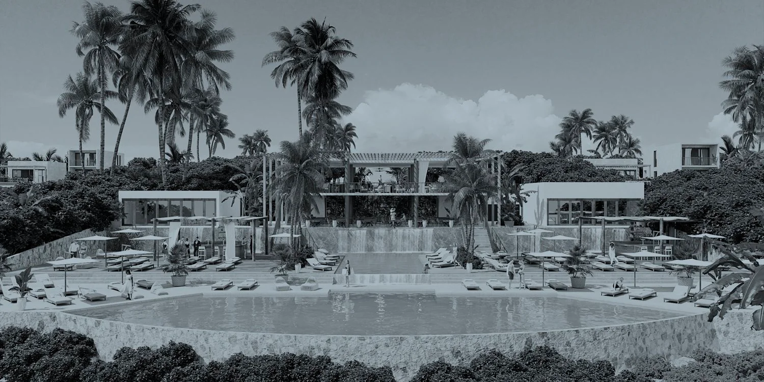 Modern resort with a spacious pool area surrounded by palm trees, lounge chairs, and vibrant vegetation, creating a tropical retreat atmosphere.