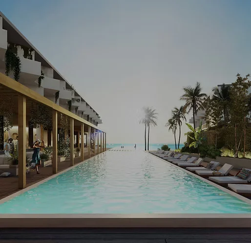 A serene infinity pool stretches towards the ocean, framed by palm trees and modern resort architecture under a clear sky.